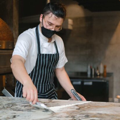 professionally cleaning kitchen worktop in a restaurant