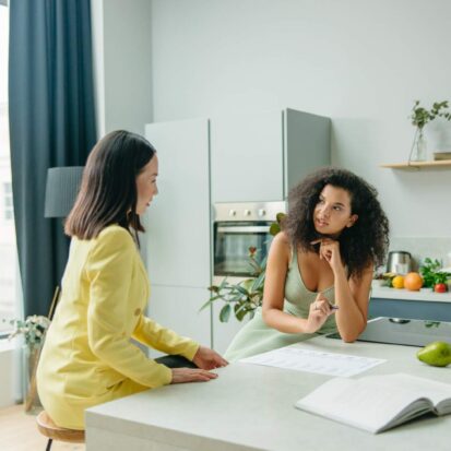 employee discussing the kitchen worktop selection process over a quartz worktop