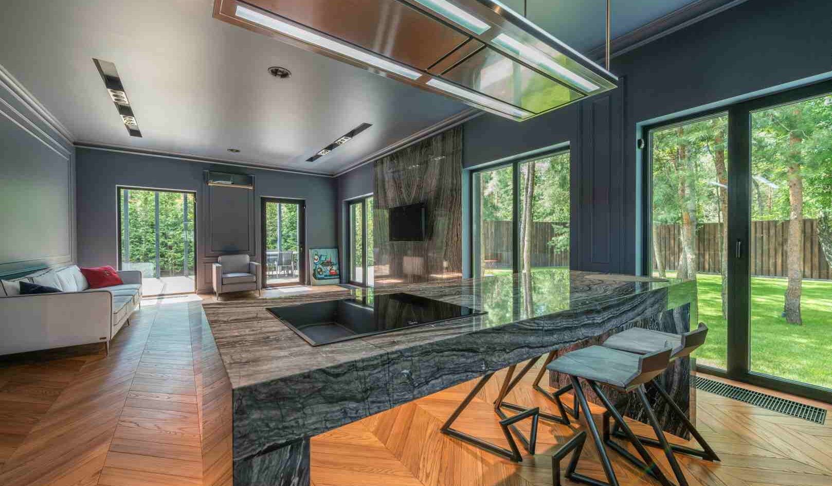 dark marble island kitchen with legs and stools modern design