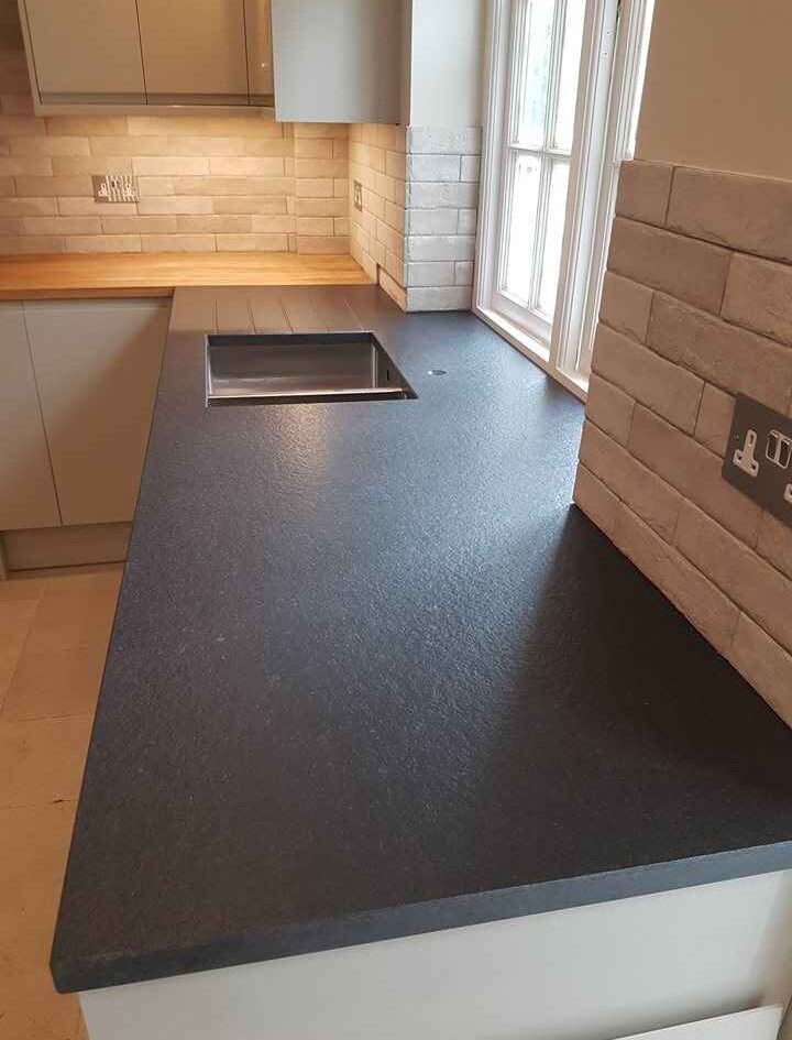 oak kitchen worktop and black granite worktop joined