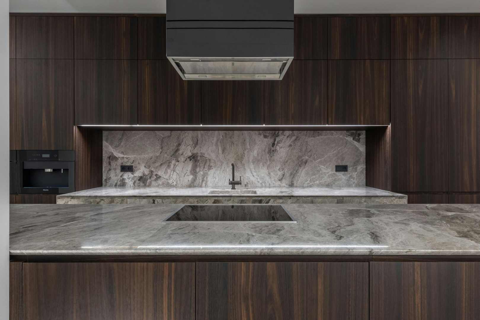 marble worktops and brown wood oak cabinets