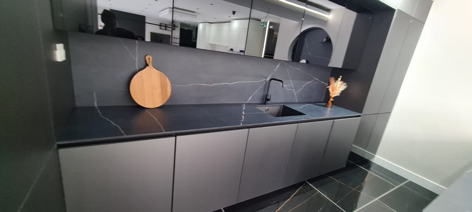 Dark quartz for kitchen worktops with splashback.